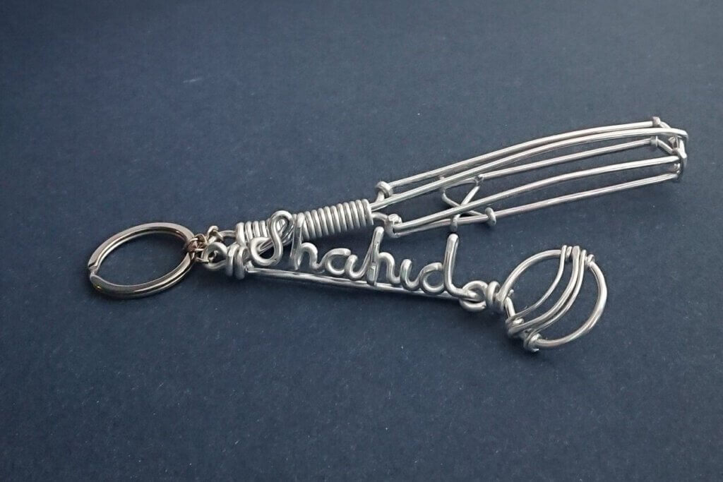 Name keychain with Cricket bat and ball. In silver.