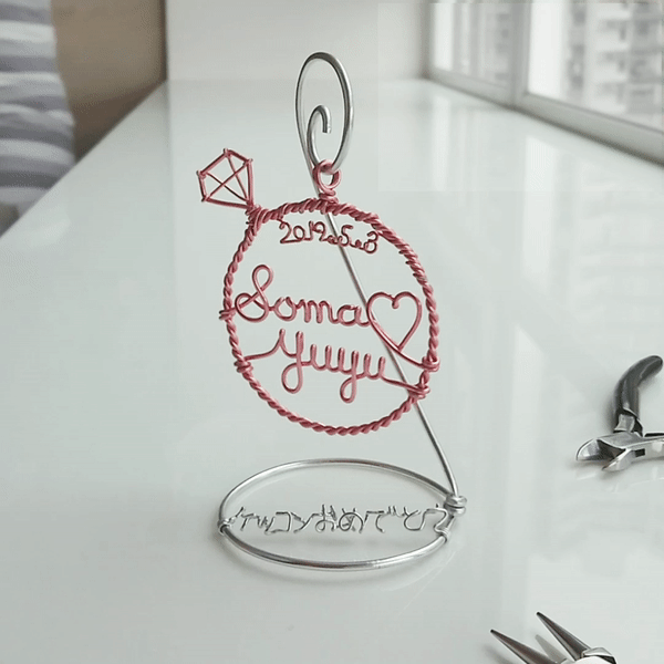 Diamond ring stand with couple names and date.
